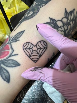 Experience the timeless beauty of a heart tattoo done in traditional black and gray style by Claudia Trash.