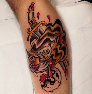 Capture the fierce beauty of a tiger and the sharpness of a dagger with this traditional tattoo by Barney Coles.