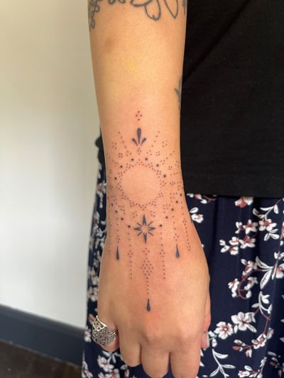 Elegant ornamental design by Indigo Forever Tattoos, showcasing a delicate star motif.