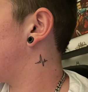 Small neck tattoo of a heartbeat underneath the ear 