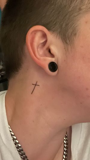 Small neck tattoo of a Christian cross ✝️