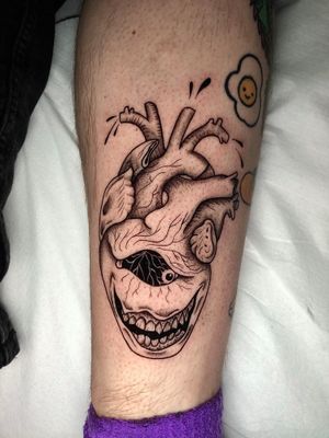 Unique and chilling dotwork tattoo by Claudia Whiteheart, featuring a twisted heart within a creepy smile design.