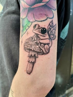 Experience enchantment with this dotwork and fine line illustrative piece by Claudia Whiteheart featuring a frog, fairy, and mushroom motif.