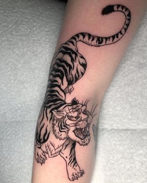 Experience the fierce beauty of a traditional Japanese tiger tattoo by the talented artist Claudia Whiteheart.