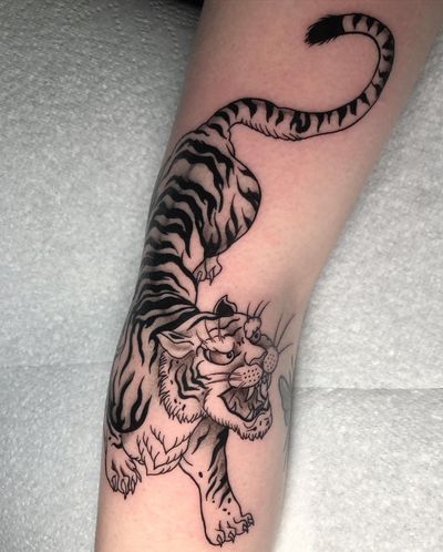 Experience the fierce beauty of a traditional Japanese tiger tattoo by the talented artist Claudia Whiteheart.
