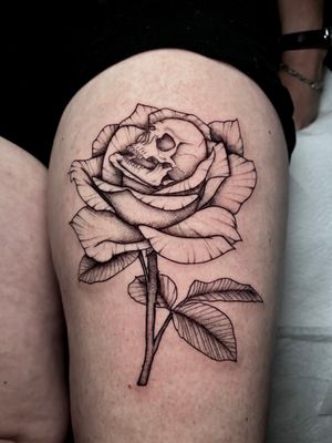 Experience the intricate beauty of dotwork and fine line details in this unique tattoo design combining a flower and skull motif. Created by the talented artist Claudia Whiteheart.