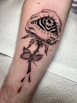 Unique dotwork style tattoo of a carnivorous plant with an eye, expertly done by Claudia Whiteheart.