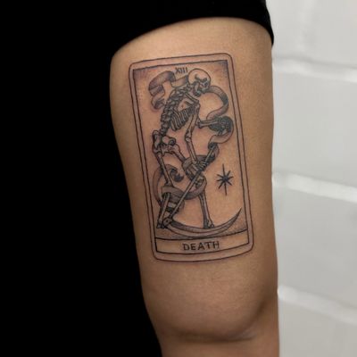 Unique dotwork and fine line illustrative tattoo by Jenny Dubet featuring a reaper motif on a tarot card design.