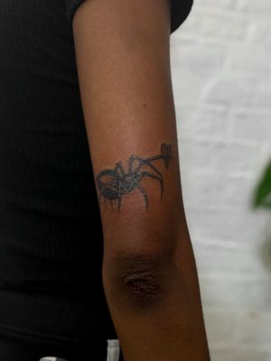 Get inked with this intricate dotwork spider and heart design by Jenny Dubet for a unique and stylish look.