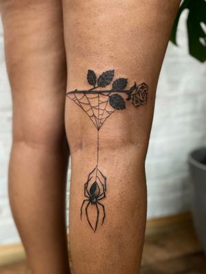 Beautifully detailed tattoo featuring a spider, rose, and spiderweb, done by the talented artist Jenny Dubet.