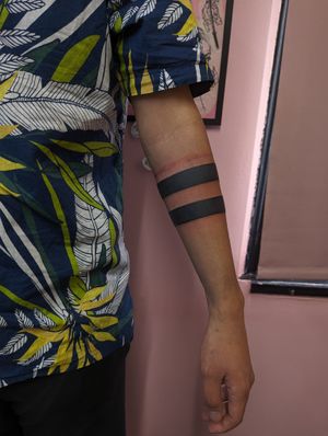 Get a bold and stylish blackwork arm band tattoo by the talented artist Luca Salzano. This sleek design will make a statement on your arm.