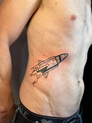 Achieve liftoff with this intricate fine line and illustrative tattoo of a rocket and space shuttle, crafted by the talented artist Jonathan Glick.