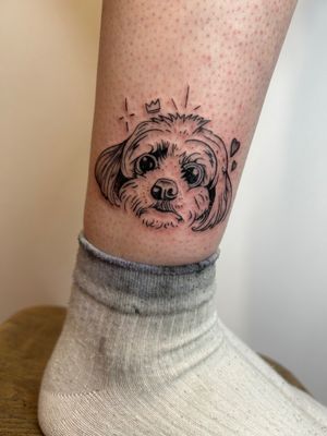 Capture your beloved pet's likeness with this detailed and expressive fine line dog portrait tattoo by the talented artist Jonathan Glick.
