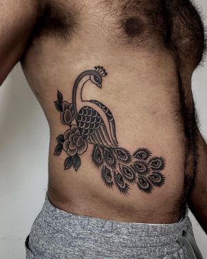 Exquisite dotwork tattoo featuring a beautiful peacock and chrysanthemum design created by the talented artist Lamat.