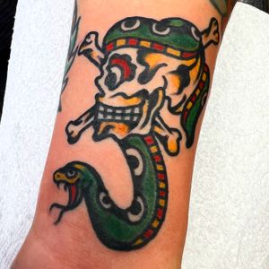 Impressive traditional tattoo design featuring a snake and skull, created by the talented artist Alessandro Lanzafame.