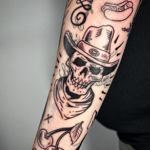 Get a unique illustration of a cowboy skull with a hat, expertly done by tattoo artist Jonathan Glick.