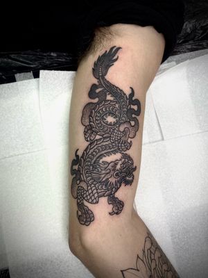 Capture the power and beauty of the mythical dragon with this intricate dotwork design by the talented artist Lamat.