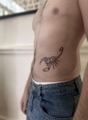 Get a striking illustrative scorpion tattoo with a traditional twist, expertly done by Maddie.