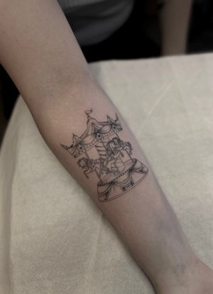 Experience the magic of the merry go round with this dotwork, fine line, illustrative tattoo by Maddie. Perfect for those who love carnival nostalgia.