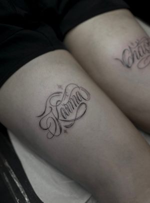 Embrace the concept of karma with this elegant fine line tattoo featuring small lettering by the talented artist Maddie.