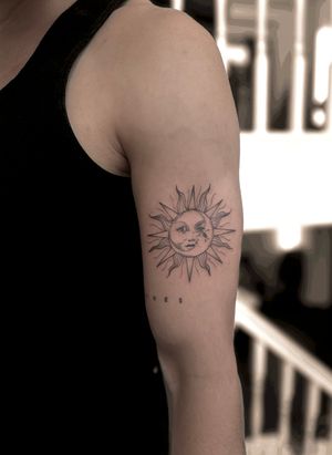 Experience the beauty of the sun and moon combined in this fine line illustrative tattoo by the skilled artist Maddie.