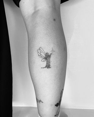 Experience the enchantment of this fine line and illustrative tattoo featuring a star, cat, and fairy. Created by the talented artist Vera.