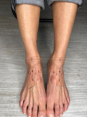 Elegant dotwork design by Indigo Forever Tattoos, featuring a delicate star motif on the ankle.