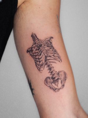 Experience the intricate detail of a fine line, black and gray micro realism tattoo featuring a skeleton by the talented artist Oscar Jesus.