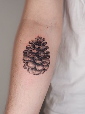Experience the beauty of nature with this exquisite black and gray botanical tattoo by Oscar Jesus.