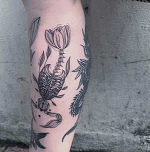 Unique black and gray design by Kiky Flore combining dotwork and fine line techniques for a stunning skeletal fish motif.