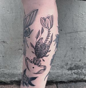 Get inked by Kiky Flore with this intricate fine line skeleton design on your lower leg. Perfect for a unique and edgy look.