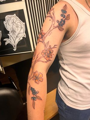 Exquisite neo traditional style tattoo of a blueberry branch by Kiky Flore, featuring fine line details and intricate illustrations.