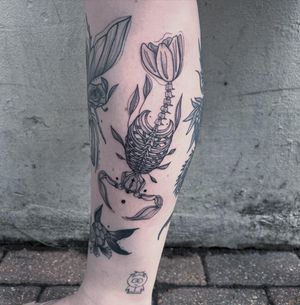 Unique black and gray illustrative design combining fish and skeleton motifs with delicate dotwork and fine lines.