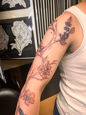 A stunning neo traditional fine line tattoo of delicate blueberry branch by talented artist Kiky Flore.