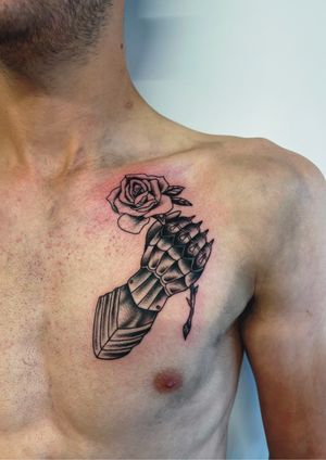 Traditional meets modern in this stunning tattoo by Kayleigh Cole, featuring a detailed rose and gauntlet on hand. Perfect for those who appreciate both old-school and illustrative styles.