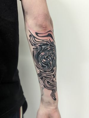 Experience the mesmerizing beauty of abstract, wavy lines in this blackwork tattoo by renowned artist George Antony.