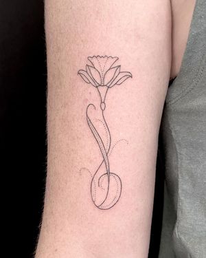 Experience the intricate beauty of this dainty flower tattoo by Indigo Forever Tattoos. Skillfully crafted in a fine line, ornamental style.