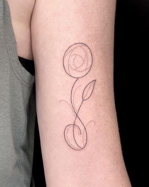 Elegant and dainty flower design by Indigo Forever Tattoos, expert in ornamental fine line tattoos.