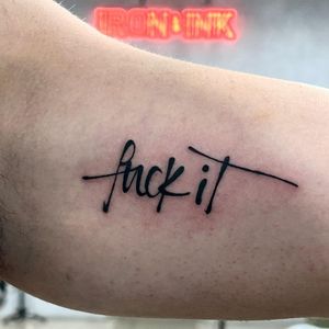 Get this rebellious yet subtle small lettering tattoo by Seven for an empowering reminder.