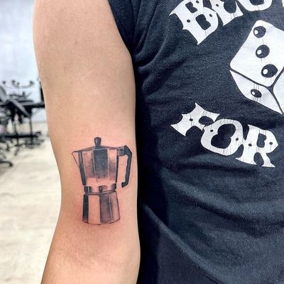 Get your caffeine fix with this intricate black and gray micro realism tattoo of a moka pot by Seven.