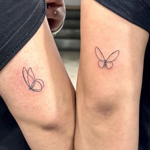 Exquisite fine line butterfly tattoo created with a continuous single line design by the talented artist Seven.