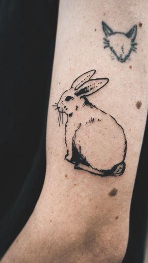 Get inked with Seven's illustrative rabbit design, a cute and stylish addition to your body art collection.