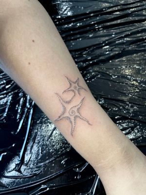 Unique dotwork style tattoo by Claudia Whiteheart featuring a star and swirl motif. Perfect for those looking for a modern and artistic design.