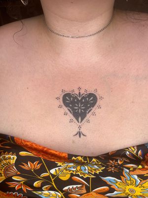 Get a unique and intricate heart design in dotwork style by Indigo Forever Tattoos. Perfect for a minimalist and elegant look.