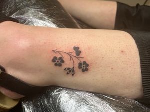 Elegant hand-poked floral design by Indigo Forever Tattoos; a delicate and timeless piece of art.