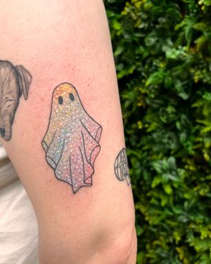 Get a cute and sparkly ghost tattoo with fine line and illustrative style by the talented artist Rachel Angharad.