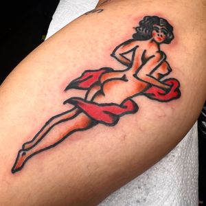 Embrace the beauty of a classic pin up woman as your muse with this stunning traditional tattoo by Alessandro Lanzafame.