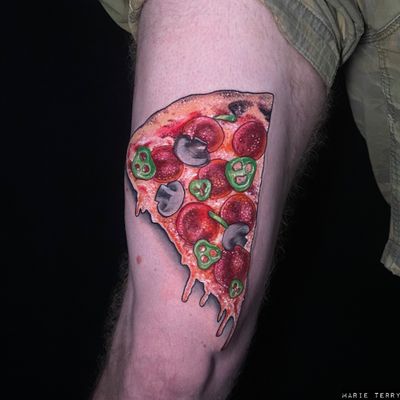 Indulge in delectable realism with this mouth-watering pizza thigh tattoo skillfully executed by the talented artist Marie Terry.