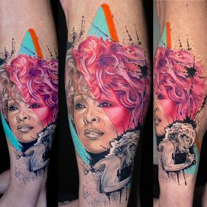 Celebrate the iconic Tina Turner with a vibrant and realistic watercolor tattoo by Marie Terry on your shin.