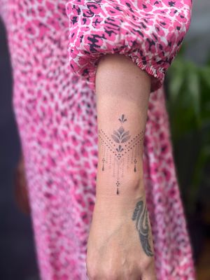 Elegant lotus flower design in intricate dotwork style by Indigo Forever Tattoos.